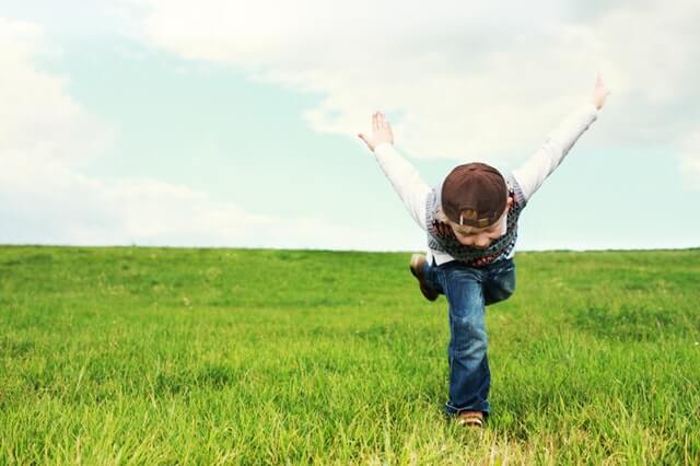 kid running in a field