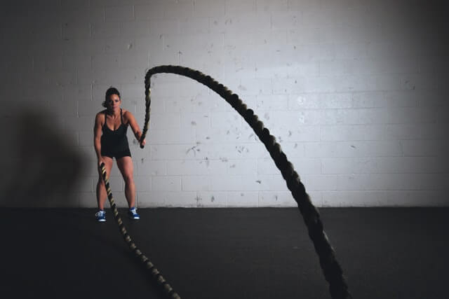 a woman doing fitness with ropes